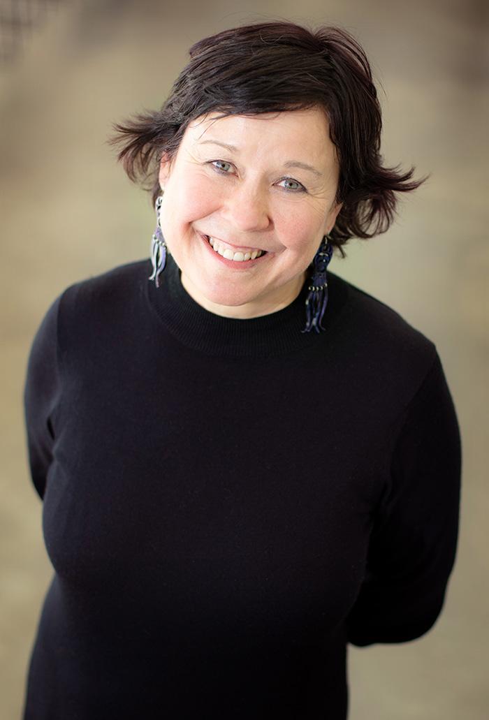 a smiling woman in a black sweater